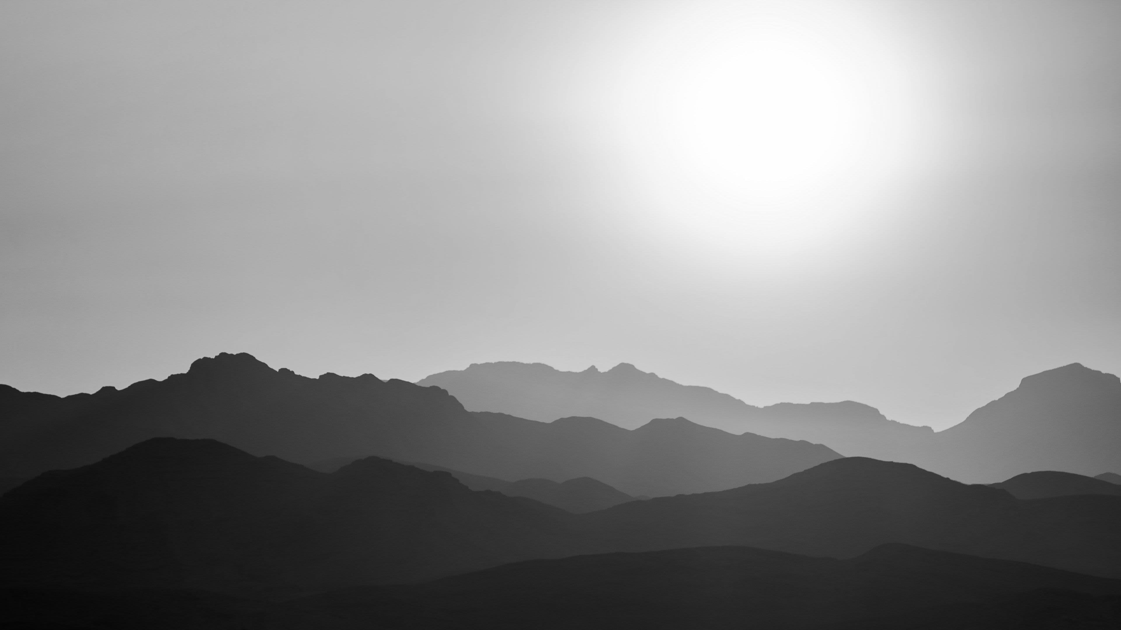 silhouette of mountains under orange sky